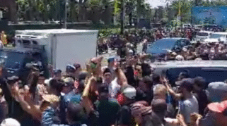 Dua kelompok massa berunjuk rasa di depan gedung rapat pleno.