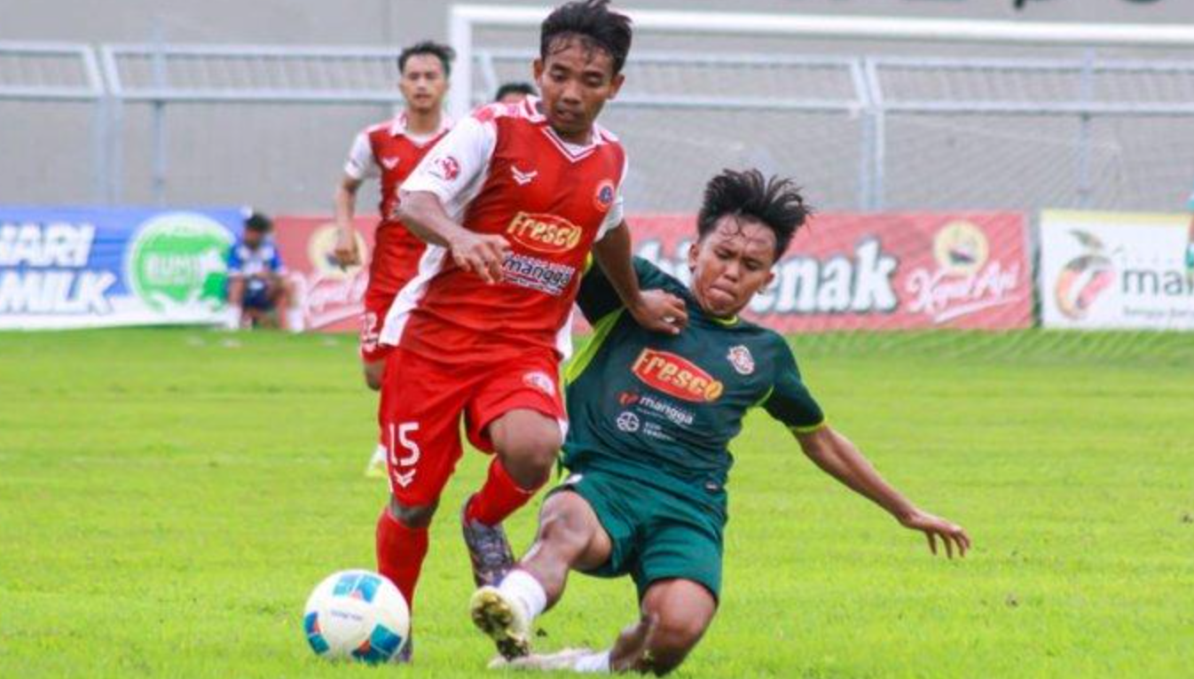 Pemain Persedikab Kediri dan Mitra Surabaya berebut bola.